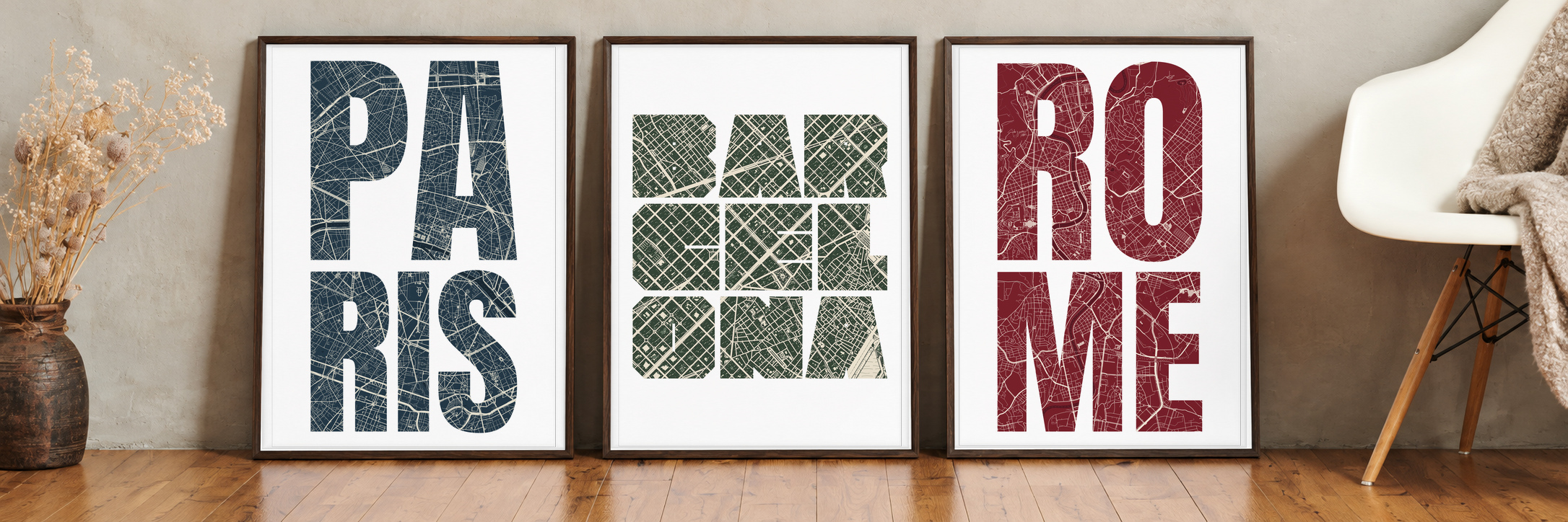 Paris, Barcelona and Rome typography maps in three A2 frames, photographed close up beside a chair and a vase